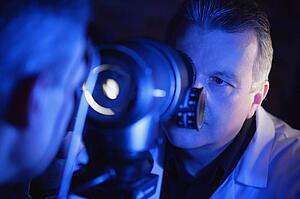 Optometrist administering an eye exam