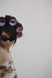 A woman with curlers in her hair