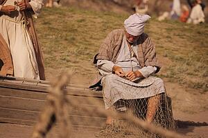 A fisherman mending his nets