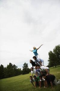 A group of young people making a pyramid