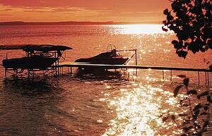 Sunset over the lake and silhouette of boats