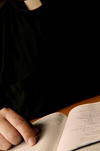 A minister reads the Bible