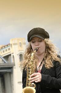 A young woman playing the saxophone