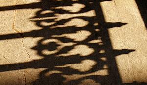 Shadow of an iron fence