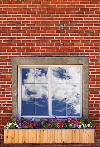 A window with the cloudy sky reflecting in it
