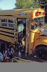 Children loading a school bus