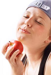 Child bites into apple