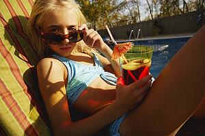 Child relaxes beside pool