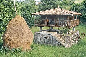 Traditional Stone Granary (Horreo) with Haystack in Asturias
