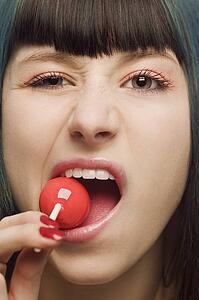 Woman trying to bite sucker