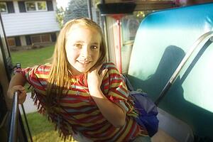 Child getting on school bus
