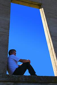 Man sitting on open ledge