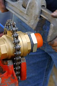 Worker fixing object with wrench