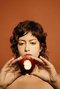 Woman holding bitten apple