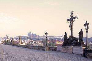 Statue of cross with urban background