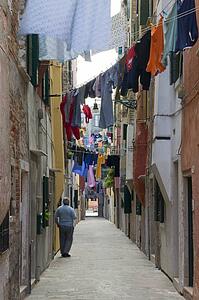 Narrow pedestrian street with hanging laundry