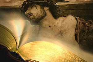 Bible with Jesus on cross in background