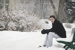 Sitting on a snowy bench