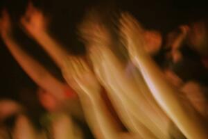 Hands raised at a concert