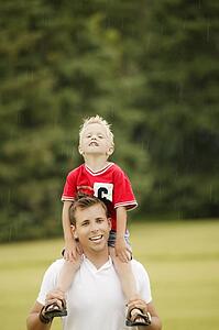 Father and son walking in rain