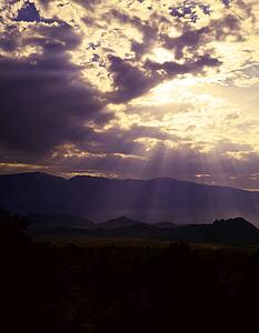 Sun rays shine down from a cloud, Owens Valley