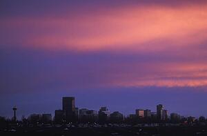 Sunset over city skyline.