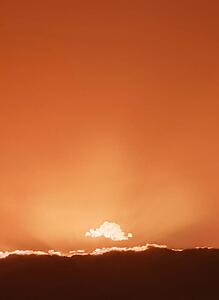 Sun setting behind clouds