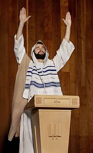 Man praying at a pulpit
