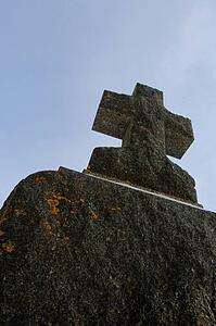 An aged cross tombstone