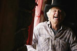 An older man laughing