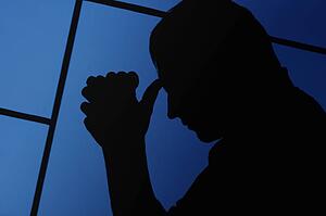 Silhouette of a man praying