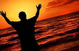 Silhouette of worshipping man