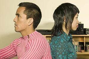 Young couple with backs together