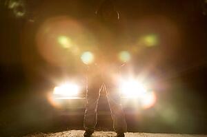 Standing in front of a car