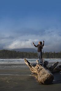 Woman with raised hands on the beach