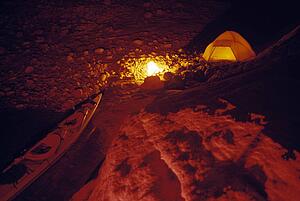 Campsite and kayak at night