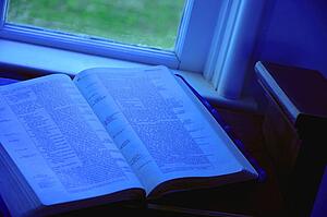 Open Bible at window side