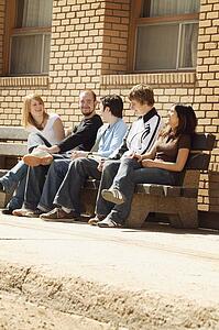 Friends talking on a bench