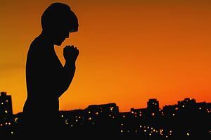 Female silhouette in prayer