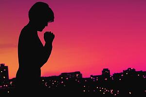 Female silhouette in prayer
