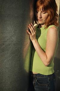 Woman standing against wall