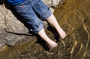 A little girls toes testing the water