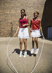 Girls jumping rope together
