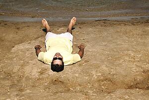 Man laying on beach