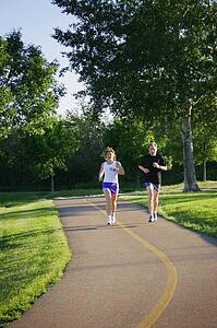 Man and woman jogging on trail