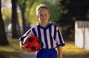 Boy carrying soccer ball