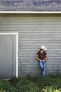 Young cowgirl on farm