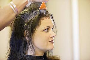 Woman having her hair dyed