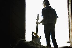 Young man holding a guitar