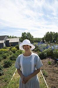 Woman in old-fashioned clothing standing in garden